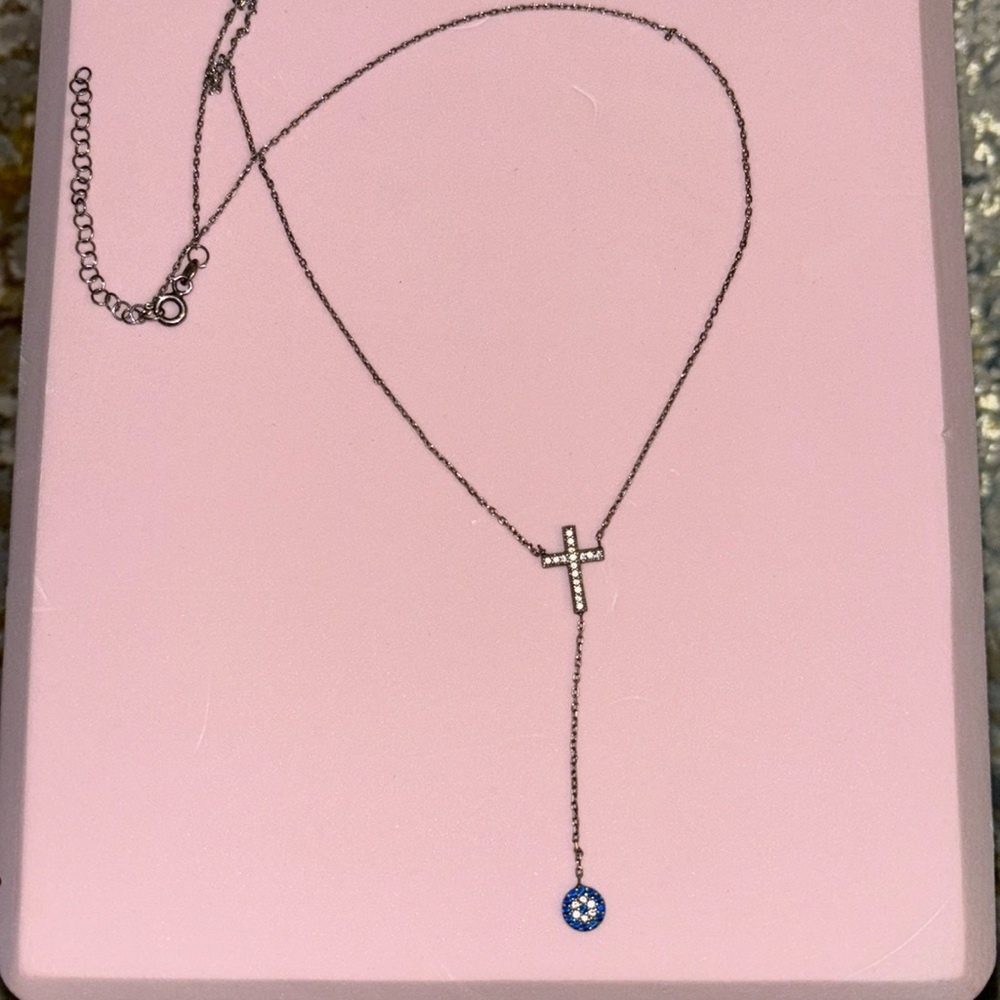 Silver cross necklace with evil eye